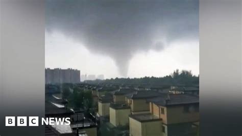 Watch: Debris flies through air as tornado hits China city .
